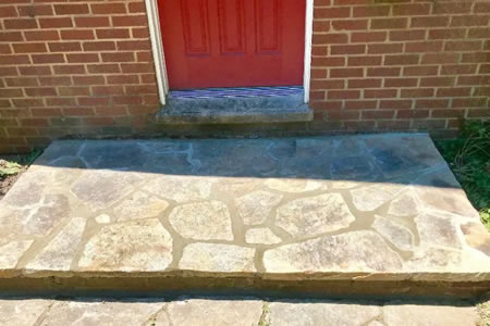 Granite stone patio in a myrtle beach backyard with ocean friendly plants